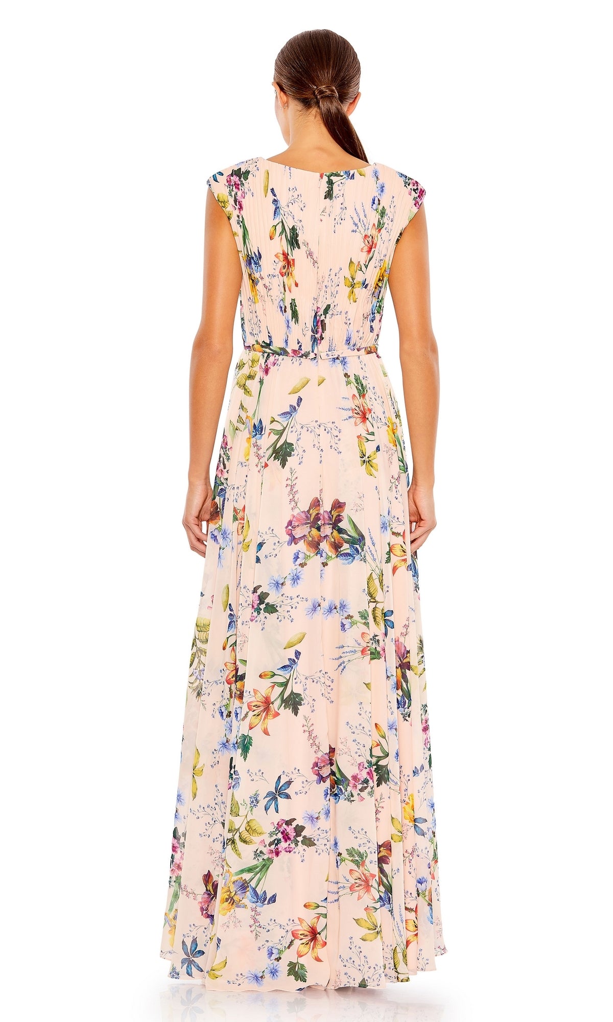 A woman is shown from the back in a Mac Duggal 55829 long floral-print formal dress in light pink, featuring a sleeveless design. Her hair is tied back in a low ponytail.